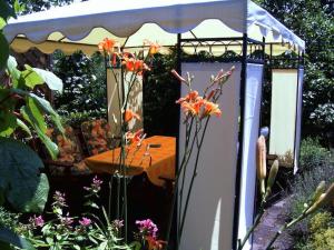 a gazebo with a table in a garden at Haus Bauer Ferienwohnung 1 in Wasserburg