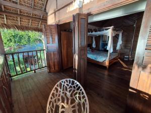 a bedroom with a bed and a balcony at Villa MAYANKI in Dzamandzar +70 photos