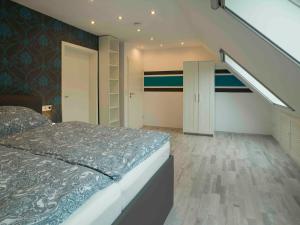 a bedroom with a large bed and a staircase at Ferienhaus am Mühlenpfad in Ottweiler