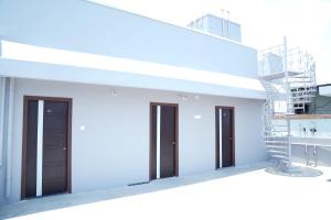 a group of doors and stairs on a white building at Hotel Vijaya Comfort in Hyderabad