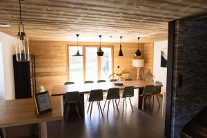 a dining room with a large wooden table and chairs at Ouréa in Génos