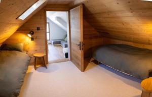 a bedroom with a bed in a wooden house at Ouréa in Génos
