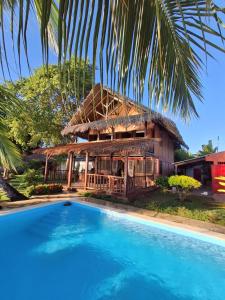 a house with a pool in front of it at Villa MAYANKI in Dzamandzar