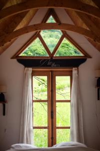 a large window in a room with a bed at Tinyhouse insolite - Au bout du chemin - 10 min de Foix in Baulou