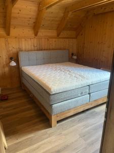 a bedroom with a bed in a wooden room at Alpenferienhaus Kreischberg in Sankt Lorenzen ob Murau