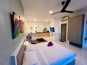 a bedroom with a bed with a red stuffed animal on it at Comfort Zone Premium Guesthouse @ Evo Bangi in Bangi