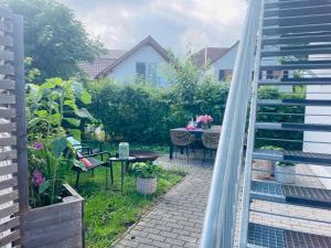 a small garden with a table and chairs on a patio at Appartement Morgensonne in Egling