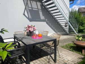 a black table with flowers and candles on a patio at Appartement Morgensonne in Egling