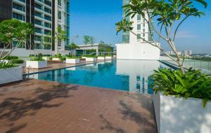 a swimming pool in the middle of a building at Comfort Zone Premium Guesthouse @ Evo Bangi in Bangi
