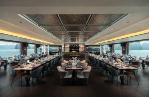 a large dining room with tables and chairs at Victorious Cruise Ha Long Bay in Ha Long