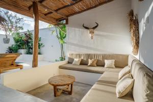 a living room with a couch and a table at Villa Ruta I - Sumptuous 2BR Luxury Villa next to Luna Beach Club and Nyanyi Beach in Tanah Lot
