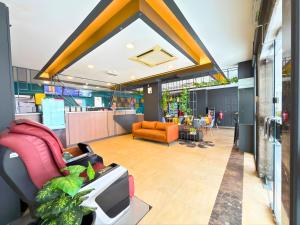 an office lobby with chairs and a tv in it at Smile Hotel Titiwangsa Pekeliling Sentul in Kuala Lumpur +26 photos