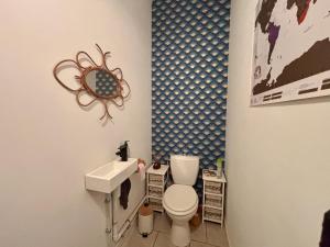 a bathroom with a toilet and a sink at Authentique maison en pierre blanche du Quercy in Castelnau-de-Montratier