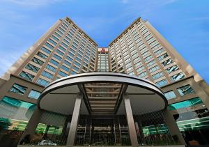 a building with two tall buildings with a circular entrance at Petaling Jaya Marriott Hotel in Petaling Jaya