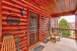 a cabin with a deck with a bench and a window at River Roost in Todd