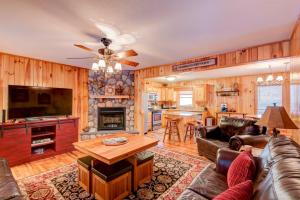 a living room with a couch and a tv and a table at River Roost in Todd