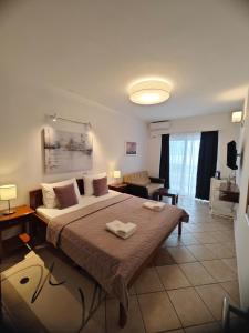 a bedroom with a large bed and a living room at Adriatic Apartment in Ulcinj