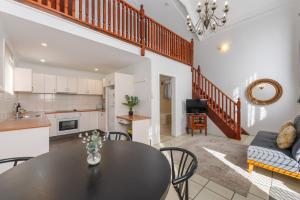 a kitchen and living room with a table and chairs at Charlesworth On The Park in Glen Innes +28 photos