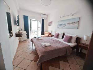 a hotel room with a bed with two towels on it at Adriatic Apartment in Ulcinj