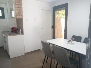 a kitchen with a table and chairs in a room at Vikendica Coco in Gornja Toplica