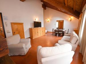a living room with two white couches and a table at Asiago Sporting Lodge - Buongiorno! Hotels in Asiago