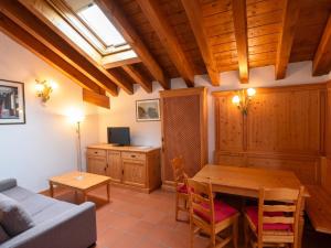a living room with a table and a couch at Asiago Sporting Lodge - Buongiorno! Hotels in Asiago