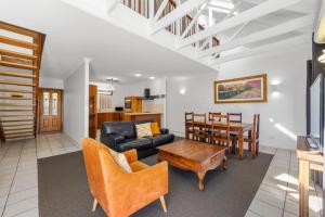 a living room with a couch and a table at Charlesworth On The Park in Glen Innes