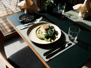 a table with a plate of food on a table at Sternen Bohlingen Aparthotel in Bohlingen