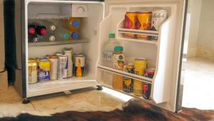 an open refrigerator filled with lots of drinks and drinks at Mystic Beach Resort in Guachaca