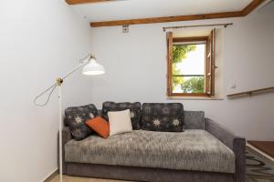 a couch in a living room with a window at Villa Zeleni raj in Omiš +32 photos