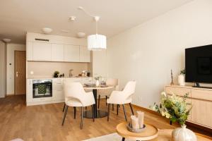 a kitchen and living room with a table and chairs at Senevita Dreiklang in Lausen