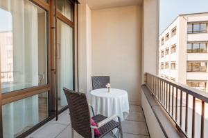 a balcony with a table and chairs on it at Senevita Dreiklang in Lausen
