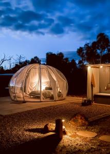 a large tent is lit up at night at Bubble Hotel in Coonabarabran +19 photos