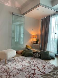 a living room with a glass shower and a couch at 1 studio seaview kalasatama Helsinki in Helsinki