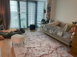 a living room with a couch and a chair at 1 studio seaview kalasatama Helsinki in Helsinki +19 photos