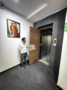 a man standing at the door of a elevator at TRPOTELS Formerly Hotel Sagar in Gwalior