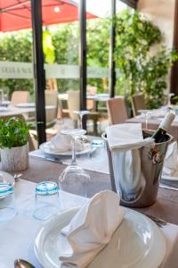 a table with a white plate and a bottle of wine at Hotel Vino in Durrës