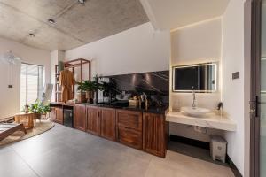 a large bathroom with a sink and a tv at ANZ Apartment in Tuy Hoa