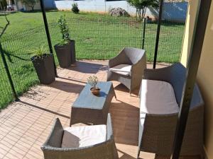 a patio with two chairs and a table and a table and chairs at Babina Hiža in Pula