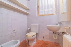 a white bathroom with a toilet and a sink at Villa Thalèa Fetovaia in Fetovaia +73 photos