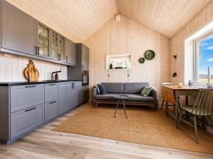 a kitchen with a couch and a table in a room at Charming cabin with a view in Gol