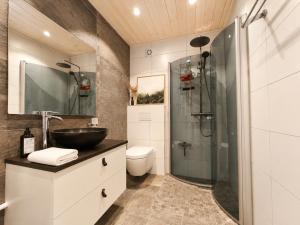 a bathroom with a sink and a glass shower at Charming cabin with a view in Gol +8 photos