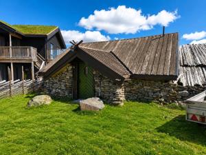 an old stone house with a green door at Charming cabin with a view in Gol