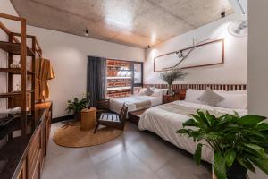 a bedroom with two beds and a window at ANZ Apartment in Tuy Hoa