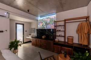 a living room with a couch and a tv at ANZ Apartment in Tuy Hoa +43 photos