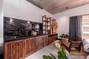 a kitchen with a sink and wooden cabinets at ANZ Apartment in Tuy Hoa