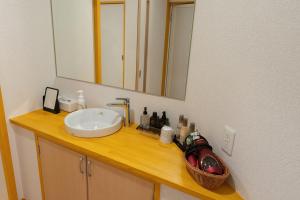 a bathroom counter with a sink and a mirror at 萩別邸 翠 HAGI Bettei SUI in Hagi