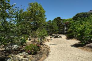 a garden with flowers and trees and a house at 萩別邸 翠 HAGI Bettei SUI in Hagi
