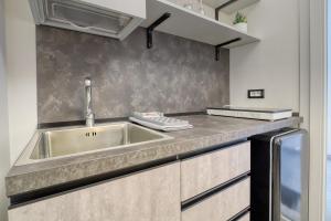 a kitchen with a sink and a counter top at Agrù - Salento Garden Stay in Cavallino di Lecce +40 photos
