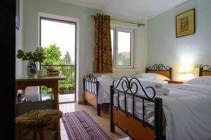 a bedroom with two beds and a balcony at Art Hotel Al Hayat in Kaji-Say